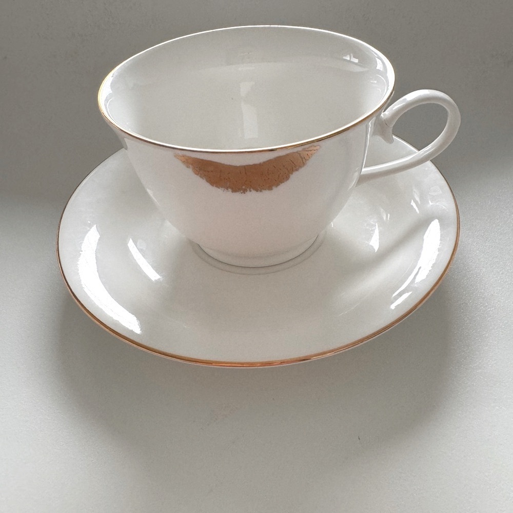 Elegant White Teacup and Saucer with Gold Trim